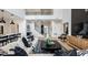 Spacious living room with an open staircase, modern decor, and lots of natural light at 536 Moon Shell Cir, New Smyrna Beach, FL 32168