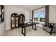 This home office showcases a modern black desk, two display cabinets and a comfy chair, ideal for a productive workspace at 536 Moon Shell Cir, New Smyrna Beach, FL 32168