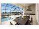 Outdoor patio with a screened enclosure, pool, and lakeside views at 536 Moon Shell Cir, New Smyrna Beach, FL 32168