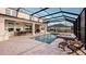 Backyard pool area with a screened-in lanai, spa, and ample seating for outdoor entertaining at 536 Moon Shell Cir, New Smyrna Beach, FL 32168