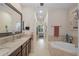 The spacious bathroom features dual sinks, granite countertops, and a large soaking tub at 5510 Siracusa Ln, Sanford, FL 32771