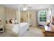 A sun-filled bedroom features a four poster bed, ceiling fan, and neutral tones at 5510 Siracusa Ln, Sanford, FL 32771