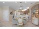 View of the kitchen from dining room boasting a glass table with chairs and stone accent wall at 5510 Siracusa Ln, Sanford, FL 32771