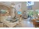 Open concept dining area with decoratively set glass table, flows into the sunlit living room at 5510 Siracusa Ln, Sanford, FL 32771