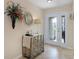 Bright foyer with tile floors, decorative mirror, and stylish console table by the front door at 5510 Siracusa Ln, Sanford, FL 32771