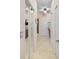 Hallway featuring neutral walls, tile flooring, and doors leading to various rooms at 5510 Siracusa Ln, Sanford, FL 32771