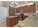 Well-equipped kitchen with dark wood cabinets, granite countertops, and a center island at 5510 Siracusa Ln, Sanford, FL 32771