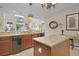 The bright kitchen features granite countertops, modern appliances, and a view of the living area, perfect for entertaining at 5510 Siracusa Ln, Sanford, FL 32771