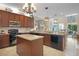 Well-lit kitchen boasts granite counters, ample cabinet space, and a central island for food preparation and gathering at 5510 Siracusa Ln, Sanford, FL 32771