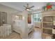 Primary bedroom suite featuring a canopy bed, ceiling fan, and wood-look flooring at 5510 Siracusa Ln, Sanford, FL 32771
