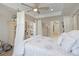 Comfortable main bedroom featuring a four-poster canopy bed and neutral decor at 5510 Siracusa Ln, Sanford, FL 32771