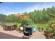 Expansive outdoor patio featuring a dining table, chairs, umbrella, fire pit, and manicured lawn at 5510 Siracusa Ln, Sanford, FL 32771