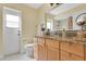 Bathroom featuring granite counters, wood cabinets, and backyard access at 5836 Goldenwood Dr, Orlando, FL 32817