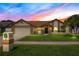 Charming single-story home with lush lawn, brick accents, and a two-car garage, creating inviting curb appeal at 5836 Goldenwood Dr, Orlando, FL 32817