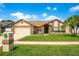 Charming single-story home with lush lawn, brick accents, and a two-car garage, creating inviting curb appeal at 5836 Goldenwood Dr, Orlando, FL 32817