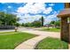 A beautiful front yard view showcasing the home's landscaping and serene neighborhood pond at 5836 Goldenwood Dr, Orlando, FL 32817