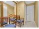 Bright hallway featuring three chairs and a mirror at 5836 Goldenwood Dr, Orlando, FL 32817