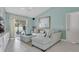 Comfortable living room with tile flooring, contemporary furniture, and sliding glass doors leading to a screened-in pool at 5836 Goldenwood Dr, Orlando, FL 32817