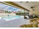 Backyard pool area with comfortable lounge seating and ceiling fans at 5836 Goldenwood Dr, Orlando, FL 32817