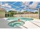 Backyard pool and spa featuring a sun-drenched screened-in patio at 5836 Goldenwood Dr, Orlando, FL 32817