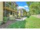 Charming backyard with a birdbath, mature landscaping, and a private screened-in porch for relaxation at 600 N Boundary Avenue # 119A, Deland, FL 32720