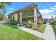 Beautiful condo featuring lush landscaping, mature trees, and a private screened-in porch for outdoor enjoyment at 600 N Boundary Avenue # 119A, Deland, FL 32720