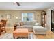 Comfortable living room featuring tile floors, neutral tones, and a cozy sectional sofa at 600 N Boundary Avenue # 119A, Deland, FL 32720