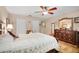 Bright main bedroom with a ceiling fan, dresser, and closet space at 600 N Boundary Avenue # 119A, Deland, FL 32720