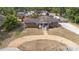 Aerial view of a brick home featuring a gravel driveway, front yard, and solar panels at 617 E Citrus St, Altamonte Springs, FL 32701