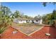 Large backyard with mulch beds, mature trees, and a well-maintained lawn at 617 E Citrus St, Altamonte Springs, FL 32701