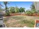 Spacious backyard with a lawn, mulch beds, and a wooden fence for privacy at 617 E Citrus St, Altamonte Springs, FL 32701