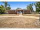 Charming single-story brick home featuring a gravel driveway, mature trees, and a welcoming front porch at 617 E Citrus St, Altamonte Springs, FL 32701