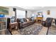 Cozy living room with hardwood floors, fireplace, comfortable leather seating, and large windows at 617 E Citrus St, Altamonte Springs, FL 32701