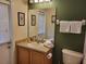 This bathroom features a sink vanity, a toilet, and a shower with a curtain at 643 Orista Dr, Davenport, FL 33897