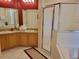 Bathroom featuring double sink vanity and glass door walk-in shower at 643 Orista Dr, Davenport, FL 33897
