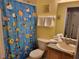 Bathroom featuring a sink vanity, toilet, tile flooring, and a blue shower curtain at 643 Orista Dr, Davenport, FL 33897