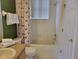 This bathroom features a sink vanity, a toilet, and a shower with a curtain at 643 Orista Dr, Davenport, FL 33897