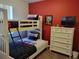 This bedroom features a bunk bed, a dresser, carpet floors, and an accent wall at 643 Orista Dr, Davenport, FL 33897