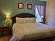 Charming bedroom features a large bed, bedside tables, and carpet flooring at 643 Orista Dr, Davenport, FL 33897