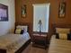 Cozy bedroom featuring two twin beds, carpet flooring and a window for natural light at 643 Orista Dr, Davenport, FL 33897