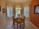 Bright dining room with bay window and elegant chandelier at 643 Orista Dr, Davenport, FL 33897