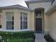 Inviting home exterior with beautiful landscaping and an arched entryway at 643 Orista Dr, Davenport, FL 33897
