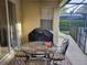 Inviting patio area with dining set and grill, perfect for outdoor meals and gatherings at 643 Orista Dr, Davenport, FL 33897