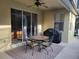 Charming outdoor patio with dining set, grill, and fan, perfect for entertaining and relaxation at 643 Orista Dr, Davenport, FL 33897