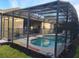 Beautiful screened-in pool area with privacy fence and mature landscaping at 643 Orista Dr, Davenport, FL 33897