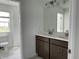 Bright bathroom featuring double vanity with quartz countertops and tile flooring at 6712 Golden Eagle Blvd, Howey In The Hills, FL 34737