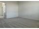 Bright bedroom featuring neutral carpet, freshly painted walls, and an open doorway at 6712 Golden Eagle Blvd, Howey In The Hills, FL 34737