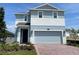 Charming two-story home featuring a brick driveway and attached two-car garage at 6712 Golden Eagle Blvd, Howey In The Hills, FL 34737