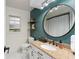 Stylish bathroom boasts a modern vanity, decorative mirror, and sleek fixtures at 7237 Edmund Ct, Mount Dora, FL 32757