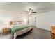 Spacious bedroom with hardwood floors, ceiling fan, and ample natural light at 7237 Edmund Ct, Mount Dora, FL 32757